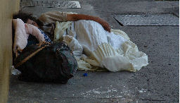 Homeless man sleeping in the street